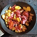 patate rosolate con pancetta tesa, aglio rosolato e fette di manzo, il pranzo di oggi