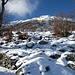 Dopo aver tolto gli zaini ed esserci sistemati, visto che manca ancora un oretta a mezzogiorno, decidiamo di tentare la salita all’Alpe Ghiaccio, che si trova 250 m sopra di noi, anche se c’è un bello strato di neve fresca. Le baite visibili a sinistra sono quelle dell’Alpe Prato di Sopra.