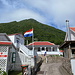 In Windwardside - Blick vorbei an der Fahne zum höchsten Berg der Niederlande. Der "Nebengipfel am Sendemast" ist zu erkennen, der Hauptgipfel aus dieser Perspektive etwas verdeckt.