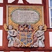 Über dem Hauptportal ist das Wappen des Fürstbischofs Johann Philipp II. von Greiffenclau (reg. 1699–1719) als aufwändig geschnitztes Holzrelief eingelassen. Bei der Erweiterung 1741 brachte man darüber eine Inschrift für den zu dieser Zeit regierenden Fürstbischof Friedrich Carl von Schönborn (reg. 1729–1746) an.