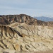 1. Stopp und Eindruck über das Death Valley: der Zabriskie Point mit Blick ins Tal. Durch Winderosion haben sich und bilden sich die Geländerücken durch den starken Wind, welcher aufgewirbelter Sand wie ein Sandstrahlgebläse über die Rücken der Hügel wirken lässt. Am Horizont die beiden höchsten Berge im Death Valley: links der Telescope Peak, 3368m; rechts der Wildrose Peak, 2763m