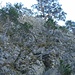 Die Schlüsselstelle: Kletterei im 3. Grat, Fels teilweise brüchig und mit Moos/Erde/Gras überwachsen. Zwei alte Bohrhacken, zwei Eisenstangen und die Bäumchen weisen den Weg.