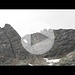 S.Bernardo, 24 settembre 2011
Eccoci qua, alla porta del passo Forato.
Io, Max, Cris e Massimo (new entry ) la meta doveva essere il Pizzo omonimo, ma per diversi motivi, tra cui le scoraggianti informazioni del gruppetto proveniente dal passo nei pressi del lago Forato che sconsigliavano la salita per la presenza di neve lungo la cresta (loro erano arrivati in elicottero dal passo). Avremmo forse avuto problemi a trovare Il canalino giusto e avremmo perso tempo , PREZIOSO ... Tutta questione di tempo ... e non di neve ...
Lasciamo l'auto a San Giacomo e con passo costante raggiungiamo la conca prativa di S. Antonio da dove parte la mulattiera. Passiamo dall'alpe Cornera 1920 m. e proseguendo su largo sentiero  arriviamo alla casa dei guardiani della diga ancora avvolta dalle nuvole.
La giornata promette bene, a monte il cielo si sta aprendo, non vediamo ancora la nostra meta ma siamo convinti e pure in anticipo sulla tabella di marcia. Massimo, per lui è una delle prime uscite, conquista  i suoi circa 1000 metri di dislivello ... velocemente e godendosi pure il paesaggio. Piccola pausa all' unica fontana e ripartiamo arrivando al Bacino del Truzzo 2080 m. Lo costeggiamo e il  Rifugio Carlo Emilio 2153 m. è lì.
Facciamo un incontro con un pastore, qualche foto con le sue pecore di stazza maxi e esigenti di cibo e coccole.
Alle spalle del rifugio se si osserva bene si notano degli ometti che segnalano la strada che dobbiamo seguire, Risaliamo il pendio di erba e rocce fino a raggiungere dei dossi che precedono il lago Forato 2420 m.. Qui incrociamo il gruppetto che scende.
Come dicevo prima ci sconsigliano la salita. Demoralizzati, ma non troppo, decidiamo ugualmente di proseguire. Risaliamo l'ultimo dosso e Massimo avendo dato già il meglio di sé decide di fermarsi causa di un dolorino fastidioso all'anca. Qui perdiamo un po' di tempo , ma fa parte del gioco e mentre Max e Cris risalgono, attendo che Massimo trovi la strada giusta verso valle . Ora risalgo velocemente arrivando alla conca erbosa del Lago di Croce 2525 m., qui la visione spazia dal passo fino alla cima del Pizzo Forato, lo raggiro da NW  tra massi e incomincio a vedere bene la meta. Arrivato da Max e Cris si decide l'avvicinamento. Arriviamo proprio sotto il passo convinti di risalirlo, ma è impossibile troppo rischioso con roccia che si sgretola (aveva ragione Max), quindi lo raggiriamo sulla dx e saliamo di un centinaio di metri riuscendo a percorre la corta cresta esposta e a sederci sulla porta del passo proprio sopra il foro!
Bene !!!
Riscendiamo dallo stesso itinerario di salita arrivando alla macchina proprio stanchi .