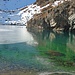 Die türkis-grüne Farbe des Wassers schimmert durch die Eisdecke.
