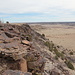 Black Mesa, am südlichen Rand des Tafelbergs - Ausblick unweit des höchsten Punktes von Oklahoma. Vorn ist gut das dunkle vulkanische Gestein zu erkennen, dass die Oberfläche des Tafelberges bedeckt. Im Hintergrund ist das südöstlich von hier gelegene Kenton zu erahnen (mittig).
