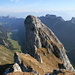 Widderalpstock Mittelgipfel and below in the foreground Namenloser Turm as seen from the Hauptgipfel. The access to the Mittelgipfel is via the grassband in the westflank which is in the shade on the right hand side, then following a groove up the south flank (the right one is easier) all the way to the peak.