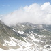 Cima Fiammante: cresta NE (al centro e verso destra nella foto) e, tra le nuvole, la vetta