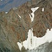 Zoom zum Anstieg zum Mitterkarjoch, über den der Normalweg zur Wildspitze verläuft. Die Schneerinne geht es hinauf bis zur Unterbrechung, dann quert der versicherte Steig nach links oben durch den Fels. Der Andrang ist enorm: im Bild dürften fast 50 Bergsteiger zu sehen sein. 