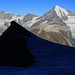 Zweiter Besteigungsversuch 17.-19.8.2012:<br /><br />Während der Kinfelsen (3635m) und das kleine Plateau vor dem Grataufschwung zu P.3812m noch im Schatten liegen strahlt das Weisshorn (4506m) hoch über dem Mattertal.