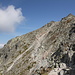 Im Aufstieg zwischen Sedlo Váha und Rysy - Ausblick vom Grat südlich des Rysy auf den Schlussaufstieg, der durch die Südwestflanke verläuft. Rechts (nicht direkt am Bildrand) ist der Hauptgipfel (2.503 m) zu sehen. Nach links schließt sich eine kleine Einsattelung an, es folgt der Nordwest-Gipfel (2.499 m, höchster Punkt von Polen) und dann der West-Grat.