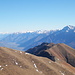 Quasi in primo piano, il Rifugio Il Giovo CAI. A sinistra la Valtellina. A destra il Legnone. Al centro le Alpi Orobie