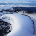 Aussicht vom höchsten Punkt auf dem Cotopaxi (5897m) zum Kraterrand der sich in einen Inneren und Äusseren Bereicht aufteilt. Der äussere Kraterrand ist weitgehend schneefrei und aus ihm steigen einzelne Fumarole auf. Der Innerere Rand ist mit Schnee und Eis bedeckt, dafür aber einfacher zu begehen.